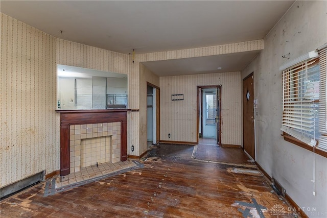 2005 Queen Ave, Middletown, OH 45044 - unfurnished living room featuring wallpapered walls, hardwood / wood-style floors, and a fireplace