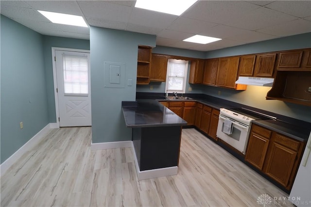 230 S 5th St, Miamisburg, OH 45342 - kitchen with under cabinet range hood, brown cabinets, open shelves, dark countertops, and a paneled ceiling