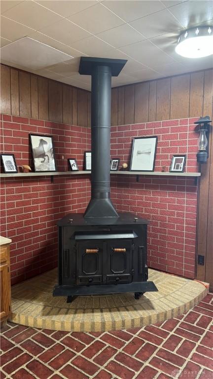 120 W Doris Dr, Fairborn, OH 45324 - detailed view of a wood stove, wood walls, and brick wall