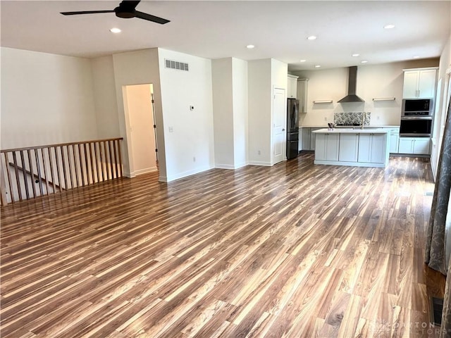559 E Fosters Maineville Rd, Maineville, OH 45039 - unfurnished living room with a ceiling fan, wood finished floors, and recessed lighting