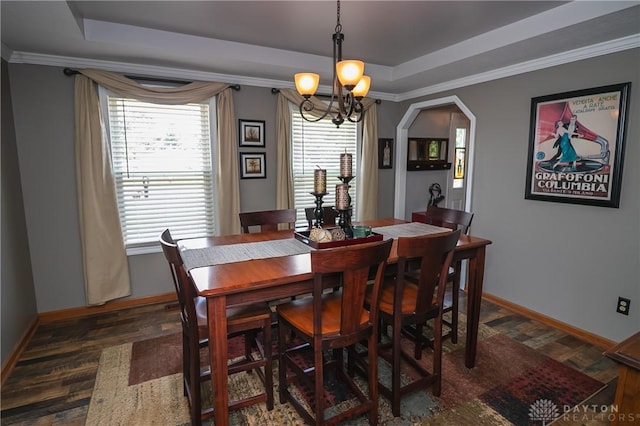 6377 Holloway Dr, Liberty Twp, OH 45044 - dining room featuring a raised ceiling, dark wood-style floors, a chandelier, crown molding, and arched walkways