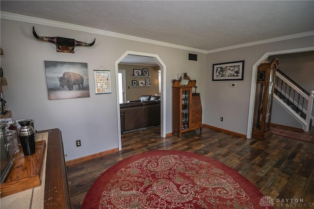 6377 Holloway Dr, Liberty Twp, OH 45044 - living area featuring arched walkways, wood finished floors, stairway, crown molding, and a textured ceiling