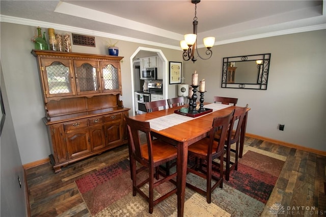 6377 Holloway Dr, Liberty Twp, OH 45044 - dining space with a raised ceiling, dark wood-style flooring, arched walkways, a chandelier, and ornamental molding
