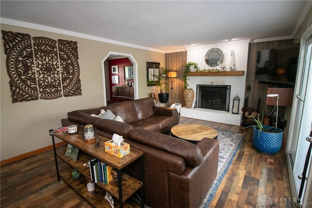 6377 Holloway Dr, Liberty Twp, OH 45044 - living room with ornamental molding, wood finished floors, a brick fireplace, and arched walkways