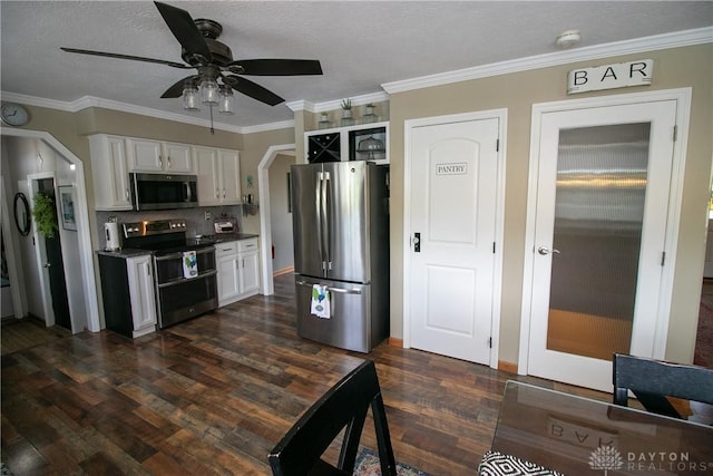 6377 Holloway Dr, Liberty Twp, OH 45044 - kitchen featuring stainless steel appliances, a ceiling fan, white cabinets, dark wood-style flooring, and decorative backsplash