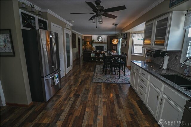 6377 Holloway Dr, Liberty Twp, OH 45044 - kitchen with freestanding refrigerator, ceiling fan, dark stone counters, dark wood-style flooring, and glass insert cabinets