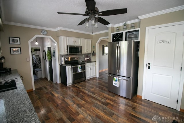 6377 Holloway Dr, Liberty Twp, OH 45044 - kitchen with appliances with stainless steel finishes, arched walkways, a ceiling fan, white cabinets, and dark wood-type flooring
