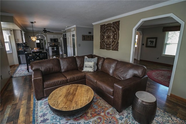 6377 Holloway Dr, Liberty Twp, OH 45044 - living area with dark wood finished floors, ceiling fan, crown molding, and arched walkways