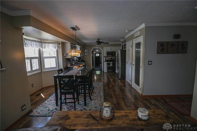 6377 Holloway Dr, Liberty Twp, OH 45044 - dining space featuring dark wood-type flooring, a ceiling fan, a textured ceiling, and ornamental molding