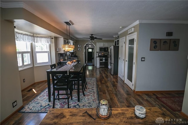 6377 Holloway Dr, Liberty Twp, OH 45044 - dining room featuring dark wood-type flooring, a ceiling fan, and crown molding