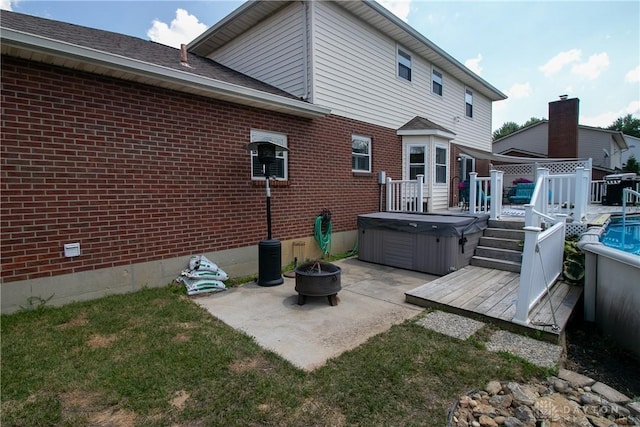 6377 Holloway Dr, Liberty Twp, OH 45044 - back of house with a hot tub, a deck, a patio, brick siding, and a fire pit