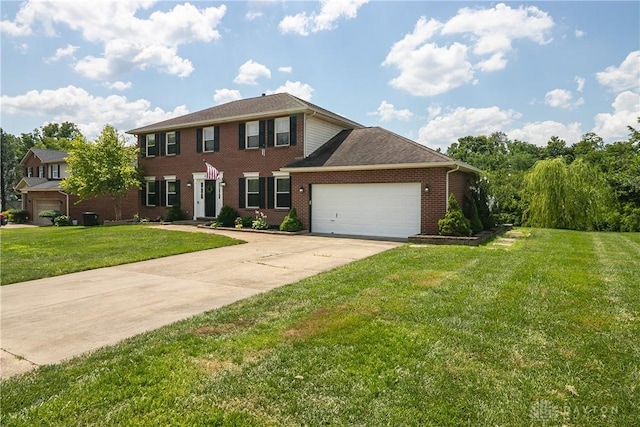 6377 Holloway Dr, Liberty Twp, OH 45044 - colonial inspired home with brick siding, an attached garage, concrete driveway, and a front yard