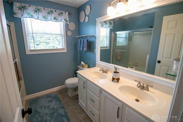 6377 Holloway Dr, Liberty Twp, OH 45044 - bathroom featuring double vanity, tile patterned floors, and bath / shower combo with glass door
