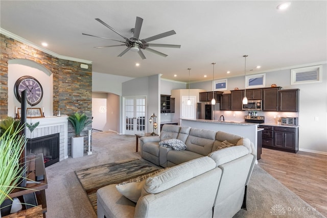 4374 Fairway Ln, Lebanon, OH 45036 - living area with arched walkways, crown molding, recessed lighting, ceiling fan, and a fireplace