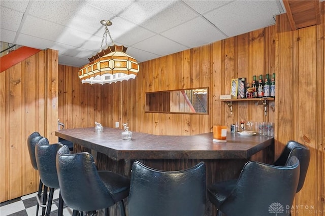 1009 Cottage Court Dr, Fairborn, OH 45324 - indoor dry bar with wood walls, a paneled ceiling, and tile patterned floors