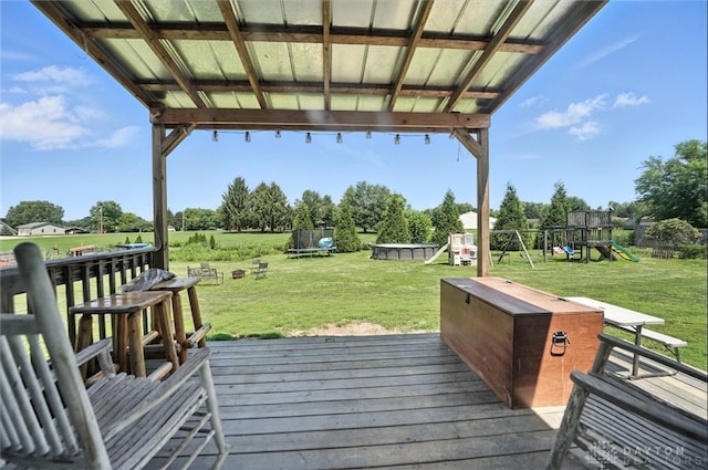 204 Ivy Creek Cv, Jamestown Vlg, OH 45335 - deck featuring a trampoline, a playground, and a lawn