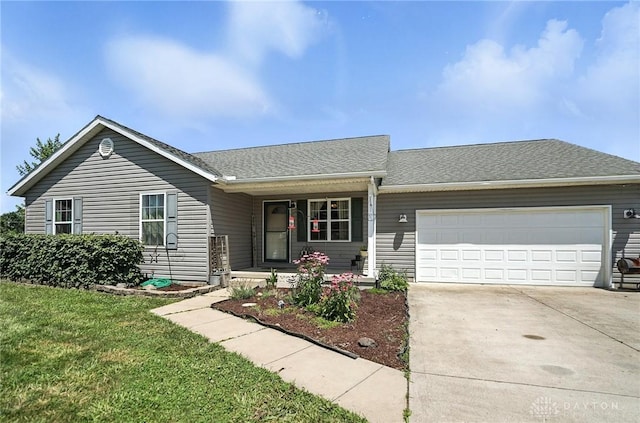 204 Ivy Creek Cv, Jamestown Vlg, OH 45335 - ranch-style house with covered porch, an attached garage, concrete driveway, a front lawn, and roof with shingles