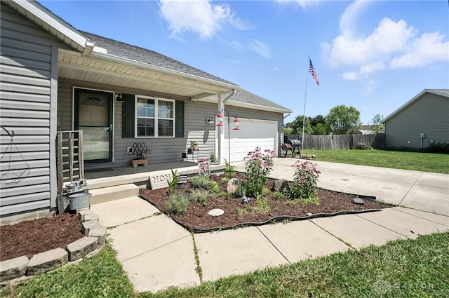 204 Ivy Creek Cv, Jamestown Vlg, OH 45335 - entrance to property with a porch, driveway, a garage, and roof with shingles