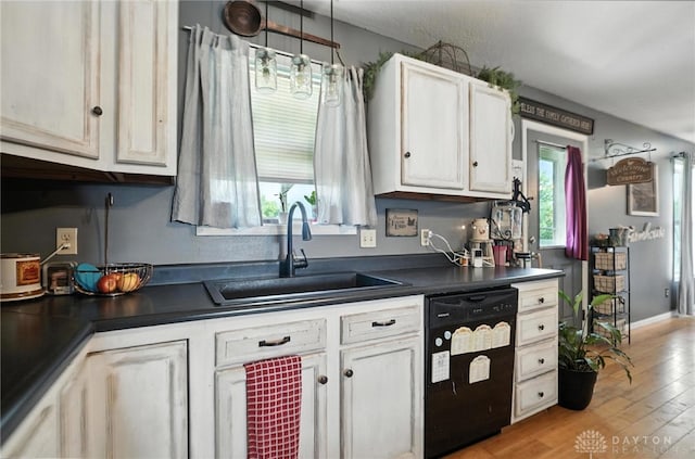 204 Ivy Creek Cv, Jamestown Vlg, OH 45335 - kitchen with black dishwasher, dark countertops, white cabinets, and light wood-style floors