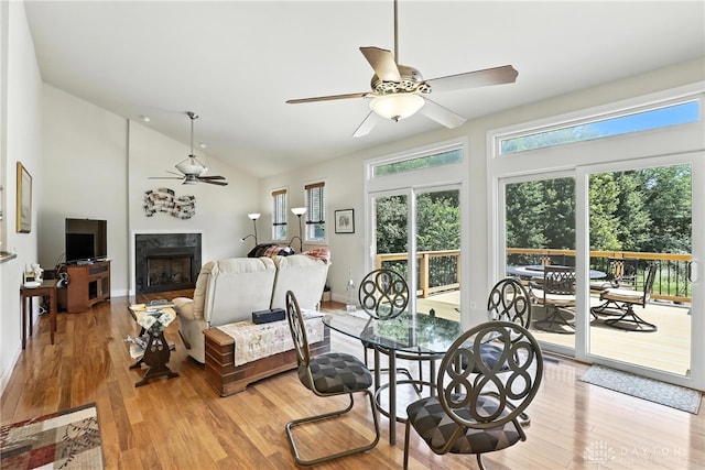 6885 Willow Creek Run, Liberty Twp, OH 45044 - dining room with ceiling fan, a premium fireplace, light wood-style flooring, and high vaulted ceiling