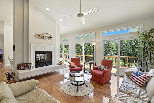 6885 Willow Creek Run, Liberty Twp, OH 45044 - living area with high vaulted ceiling, ceiling fan, wood finished floors, a tiled fireplace, and recessed lighting
