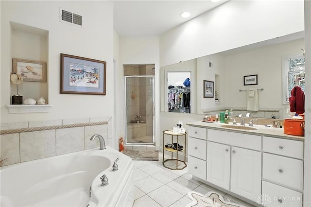 6885 Willow Creek Run, Liberty Twp, OH 45044 - bathroom featuring a shower stall, vanity, a garden tub, a spacious closet, and tile patterned flooring
