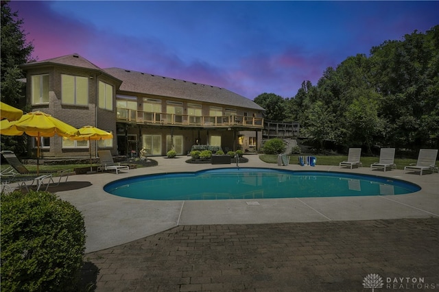 6885 Willow Creek Run, Liberty Twp, OH 45044 - pool at dusk with a patio area and an outdoor pool