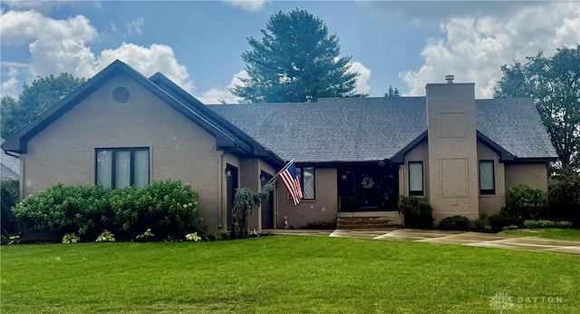 8640 Tanglewood Dr, Springboro, OH 45066 - view of front of property featuring a chimney, brick siding, a front lawn, and a shingled roof