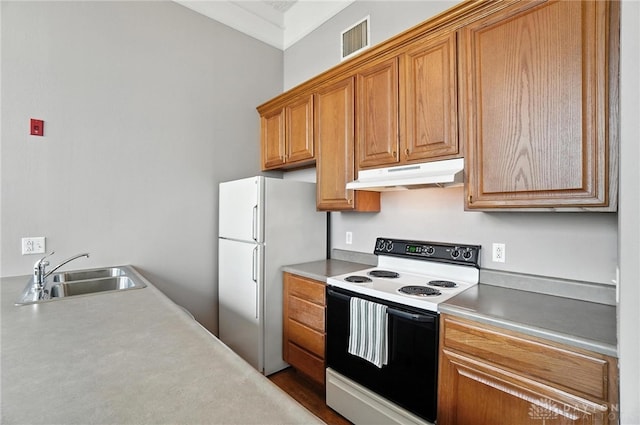 226 Mcdaniel St Unit 160, Dayton, OH 45405 - kitchen with white appliances, under cabinet range hood, light countertops, brown cabinets, and crown molding