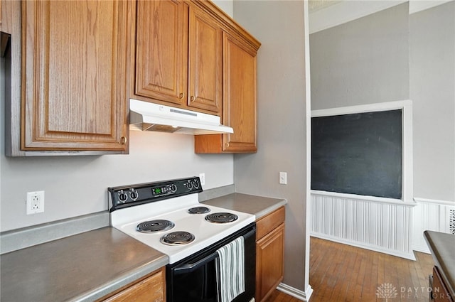 226 Mcdaniel St Unit 160, Dayton, OH 45405 - kitchen featuring range with electric cooktop, under cabinet range hood, dark wood-type flooring, and brown cabinetry