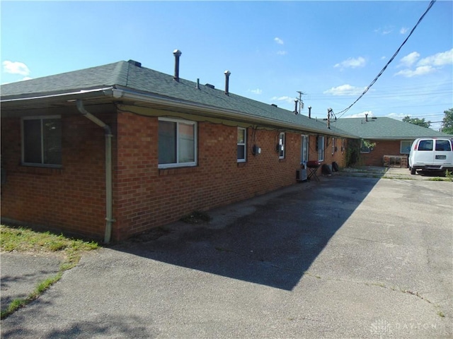2628 Saint Charles Ave, Dayton, OH 45410 - view of home's exterior featuring brick siding, driveway, and a shingled roof