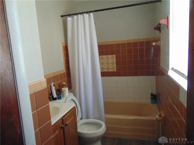 2628 Saint Charles Ave, Dayton, OH 45410 - bathroom featuring tile walls, vanity, shower / bathtub combination with curtain, and wainscoting