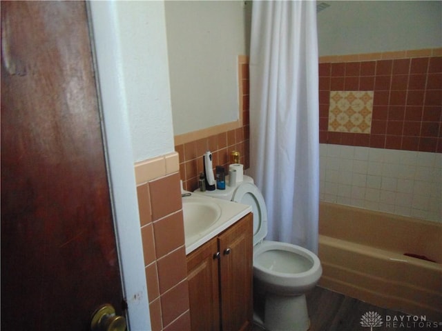 2628 Saint Charles Ave, Dayton, OH 45410 - full bath with tile walls, shower / bathtub combination with curtain, vanity, and a wainscoted wall