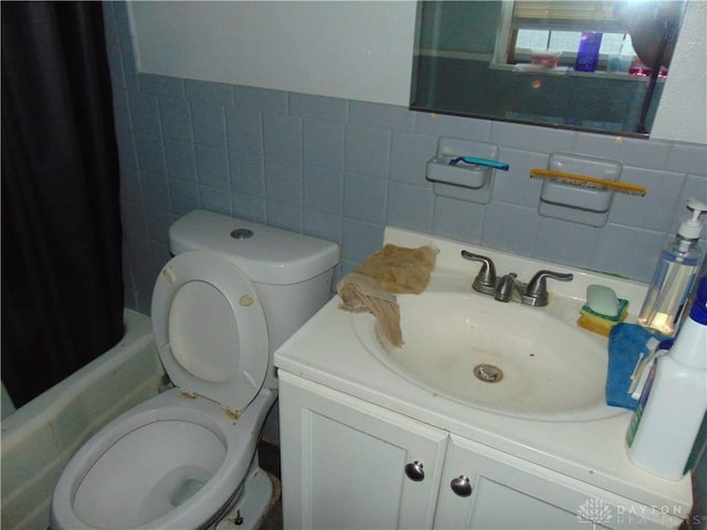 2628 Saint Charles Ave, Dayton, OH 45410 - bathroom with tile walls, vanity, shower / bathtub combination with curtain, and a wainscoted wall