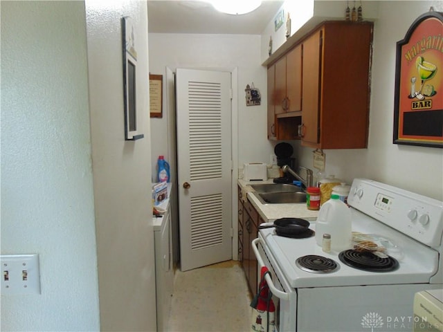 2628 Saint Charles Ave, Dayton, OH 45410 - kitchen with electric range, brown cabinets, light countertops, and washer / dryer