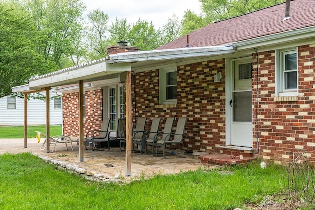 2841 Prospect Dr, Fairborn, OH 45324 - back of house featuring entry steps, brick siding, a chimney, and a patio