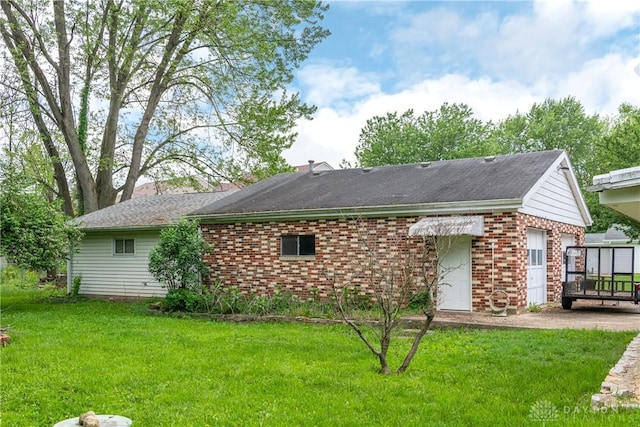2841 Prospect Dr, Fairborn, OH 45324 - rear view of property with brick siding, a garage, and a yard