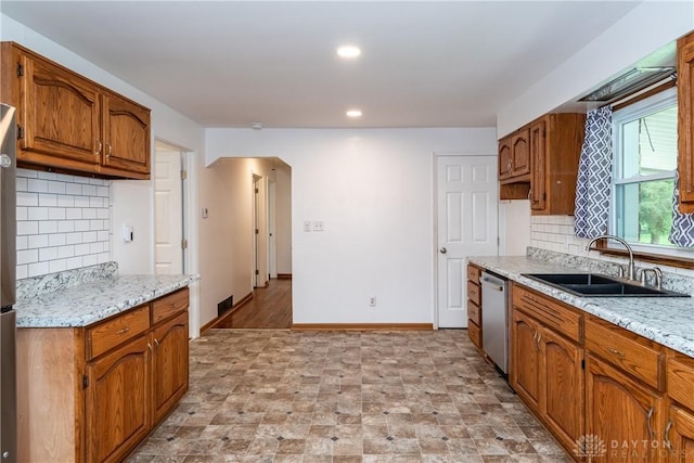 2841 Prospect Dr, Fairborn, OH 45324 - kitchen featuring dishwasher, brown cabinets, decorative backsplash, and recessed lighting