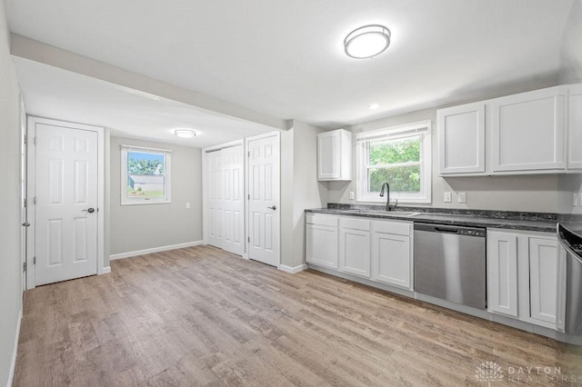 9351 Marcella Dr, Franklin, OH 45005 - kitchen with stainless steel dishwasher, light wood-type flooring, dark countertops, and white cabinetry