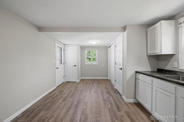 9351 Marcella Dr, Franklin, OH 45005 - kitchen featuring wood finished floors, dark countertops, and white cabinets