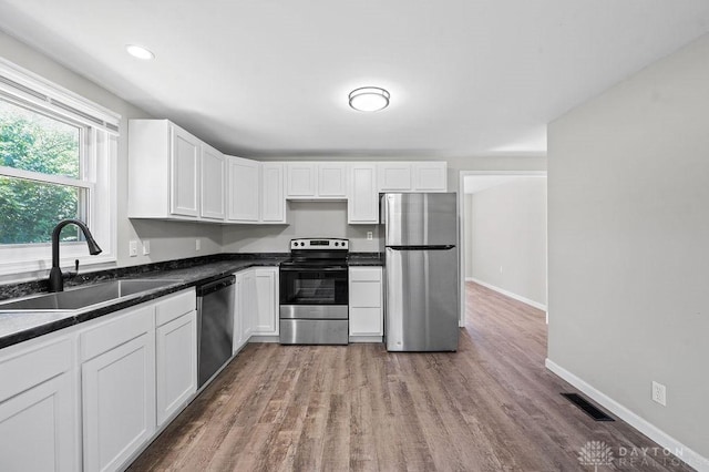 9351 Marcella Dr, Franklin, OH 45005 - kitchen with appliances with stainless steel finishes, white cabinets, light wood-style floors, and recessed lighting