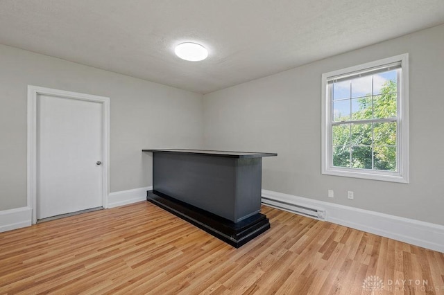 9351 Marcella Dr, Franklin, OH 45005 - spare room with a baseboard radiator and wood finished floors