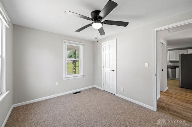 9351 Marcella Dr, Franklin, OH 45005 - unfurnished bedroom featuring freestanding refrigerator, carpet, a closet, and ceiling fan