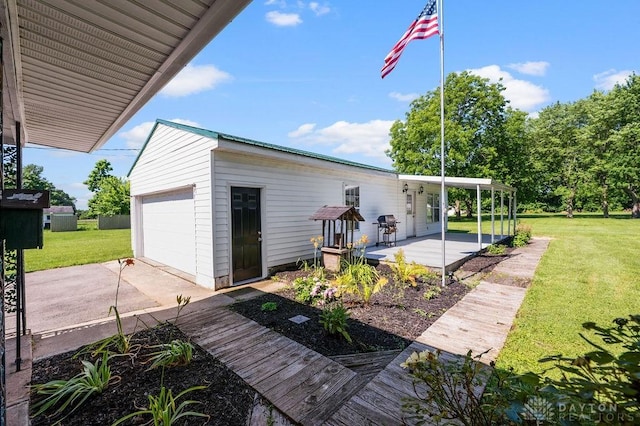 9351 Marcella Dr, Franklin, OH 45005 - wooden deck with concrete driveway, a yard, and a garage