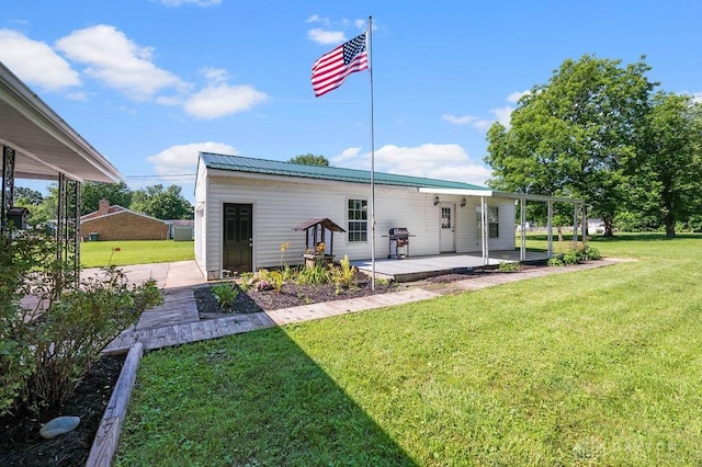 9351 Marcella Dr, Franklin, OH 45005 - back of property featuring a patio, a yard, and a metal roof