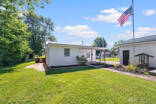 9351 Marcella Dr, Franklin, OH 45005 - rear view of house with a lawn and a metal roof