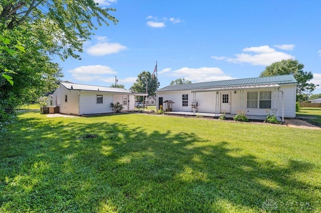 9351 Marcella Dr, Franklin, OH 45005 - rear view of property with a lawn and a metal roof