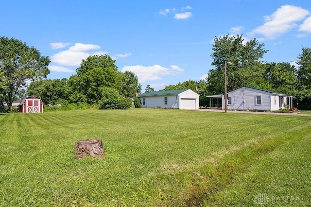 9351 Marcella Dr, Franklin, OH 45005 - view of grassy yard with an outdoor structure and a detached garage