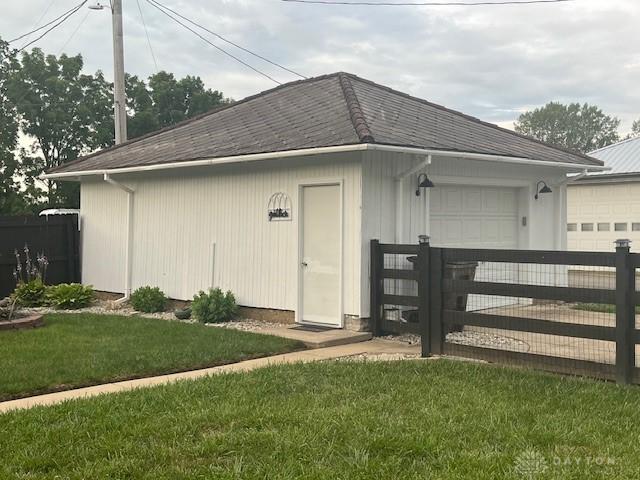 63 N Main St, West Alexandria, OH 45381 - view of outdoor structure featuring an attached garage and a gate