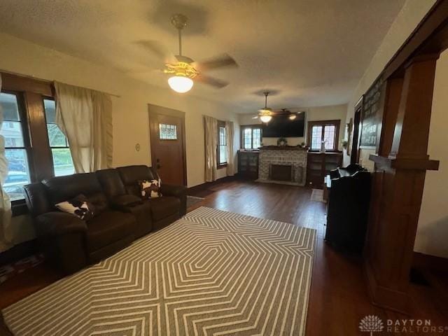 63 N Main St, West Alexandria, OH 45381 - living area featuring a ceiling fan, a fireplace, and dark wood-style flooring